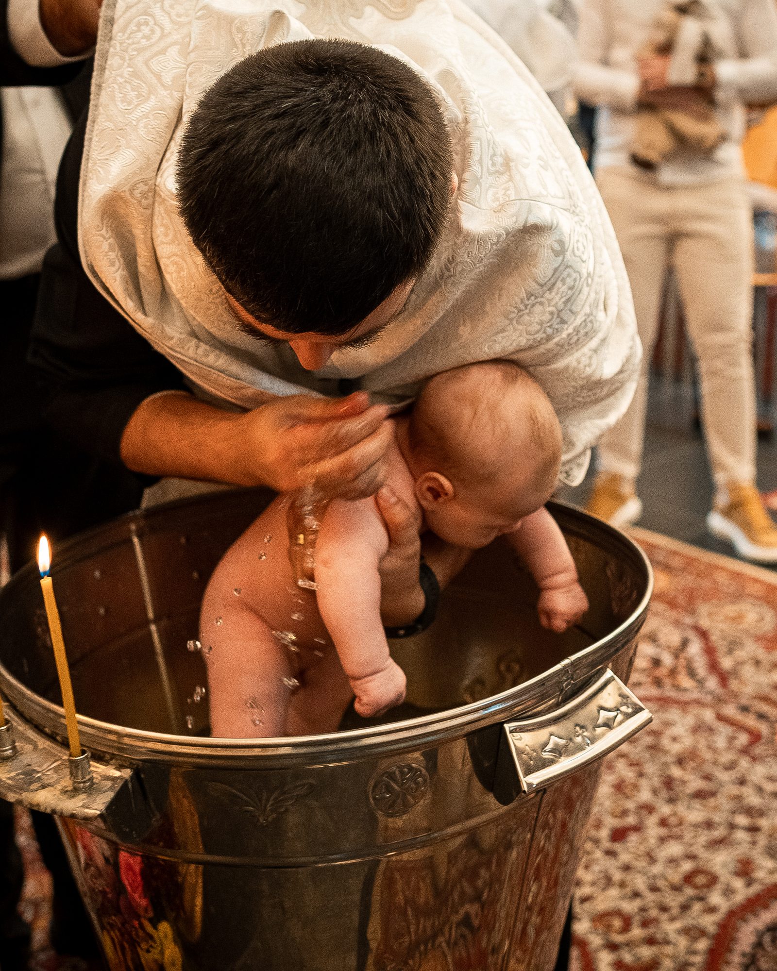 Baby being baptized during a church ceremony.