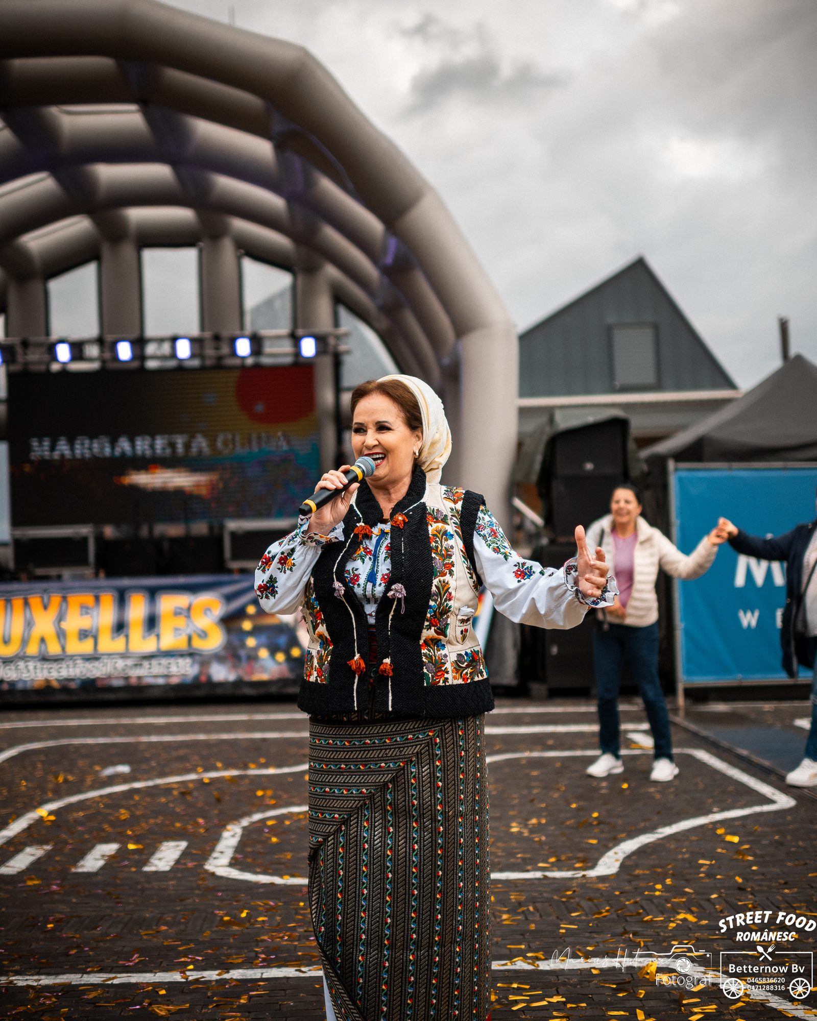 Woman hosting a cultural streetfood event on stage.