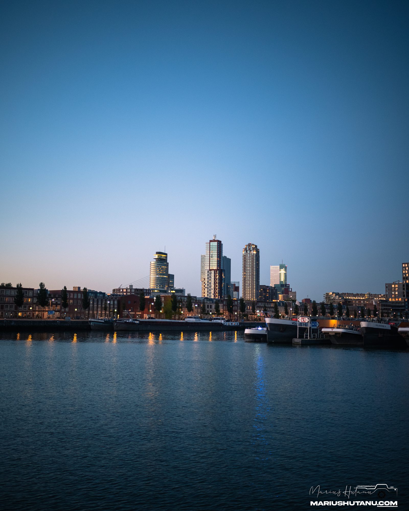 Rotterdam skyline seen from a boat during an evening event.
